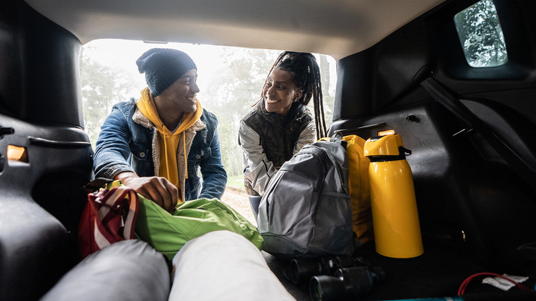 couple packing for hiking trip