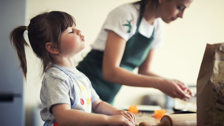 Kid and mom baking cookies