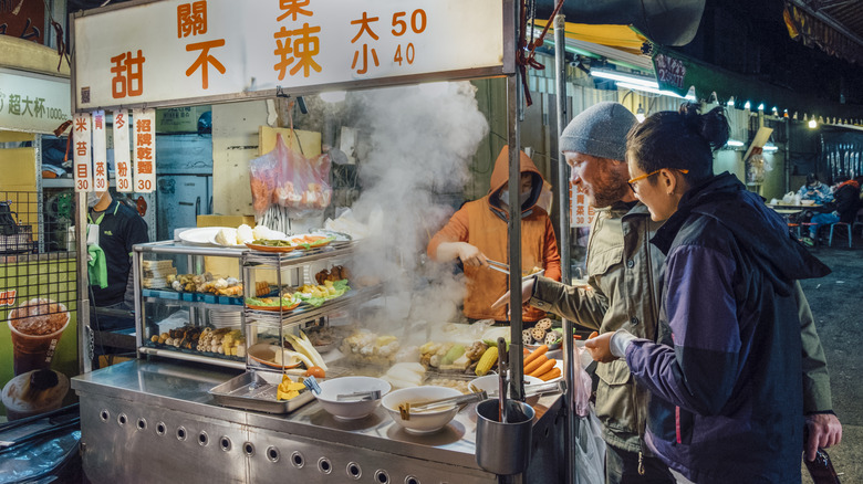 People wearing jackets in a night market