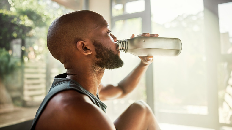 Person indoors in shade with water