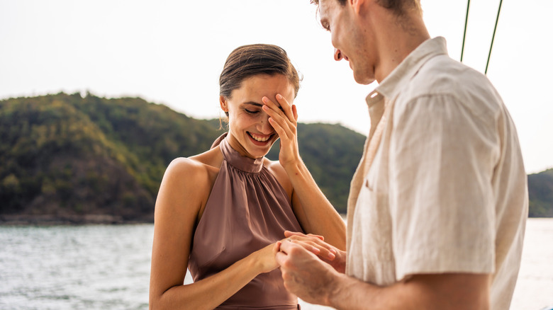 A couple getting engaged aboard a boat
