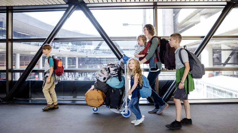 Mother in the airport with four children