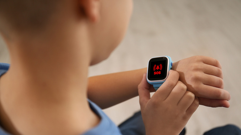 A little boy wearing a smartwatch