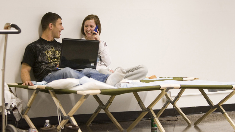 two travelers use airport cots