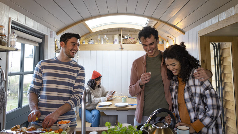 friends cooking in tiny house