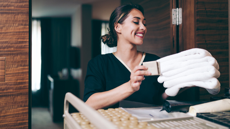 housekeeper bringing fresh towels