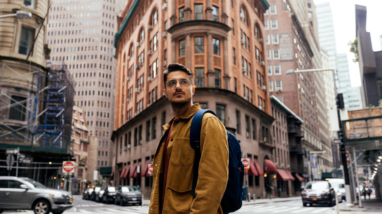 man with backpack city streets