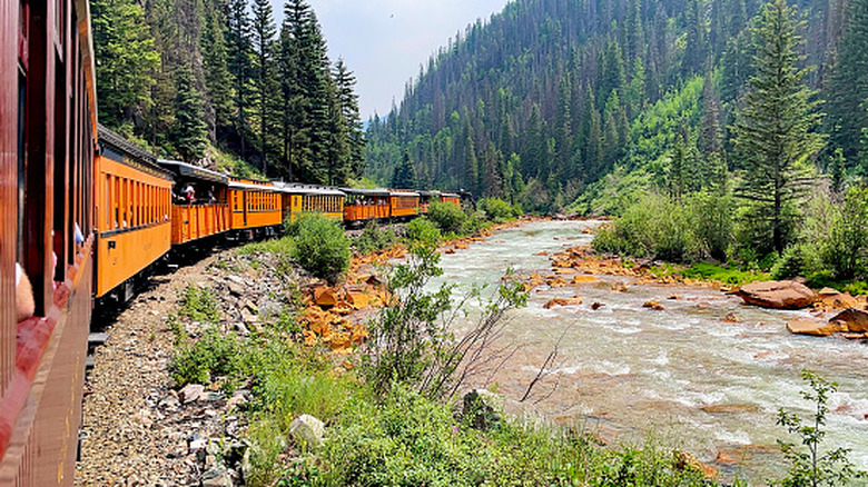 Train along a river in colorado