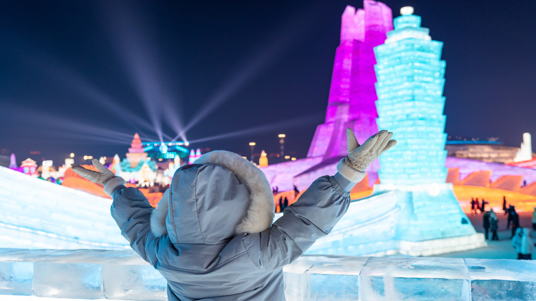 A tourist taking photos at the Ice and Snow Festival in Harbin, China.