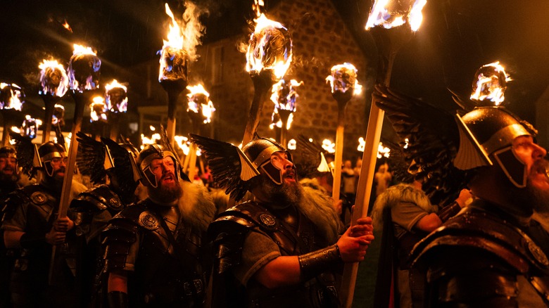 The Guizer Jarl leads with the galley and his guizers through Lerwick