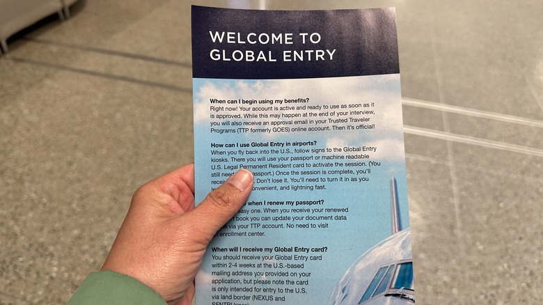 Person holding a Global Entry brochure
