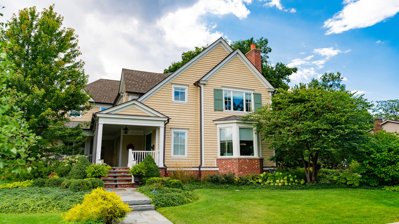 A charming timber and brick house with a green front garden in a quiet neighborhood