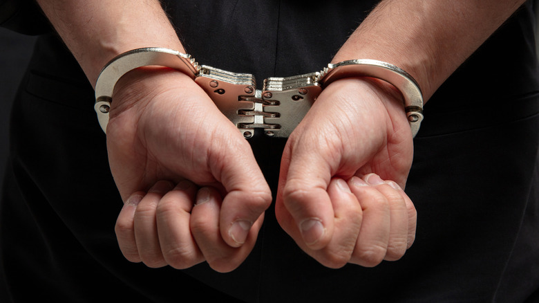 Handcuffs around person's wrists