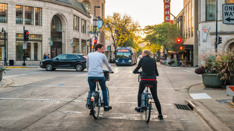 Cyclists wait at an intersection of State Street, Madison