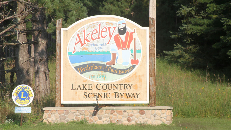 Welcome sign to Akeley with Paul Bunyan