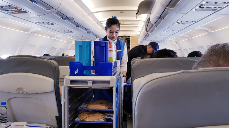 Flight attendant with beverage cart