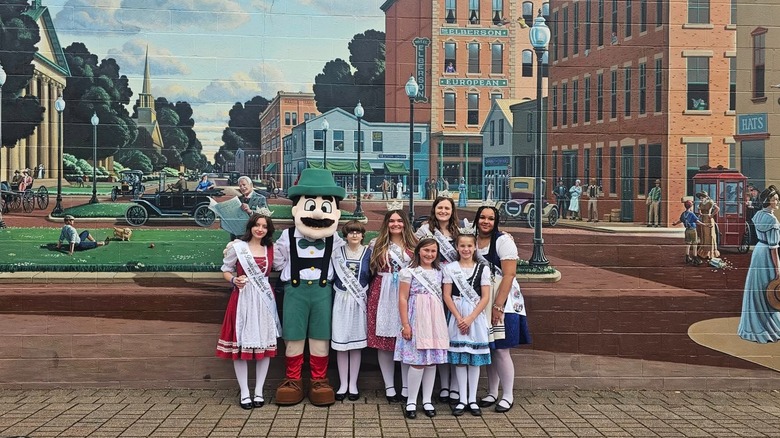 Bucyrus Bratwurst Festival royalty posing in front of the city mural, Ohio