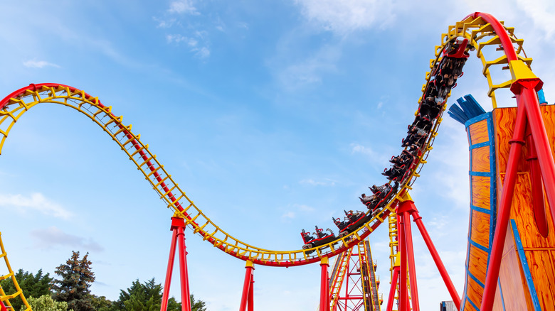 People riding roller coaster at amusement park