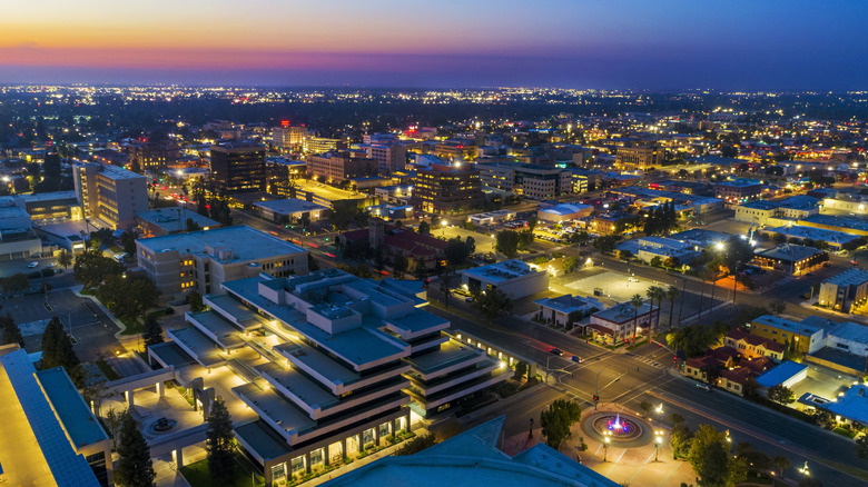 aerial view of downtown Bakersfield at night, with pink and blue hues in skyline.