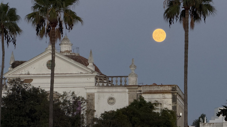The moon over buildings in Faro, Portugal