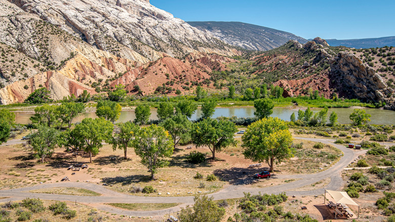 Landscape featuring rock formations, lake, trees near Dinosaur, Colorado