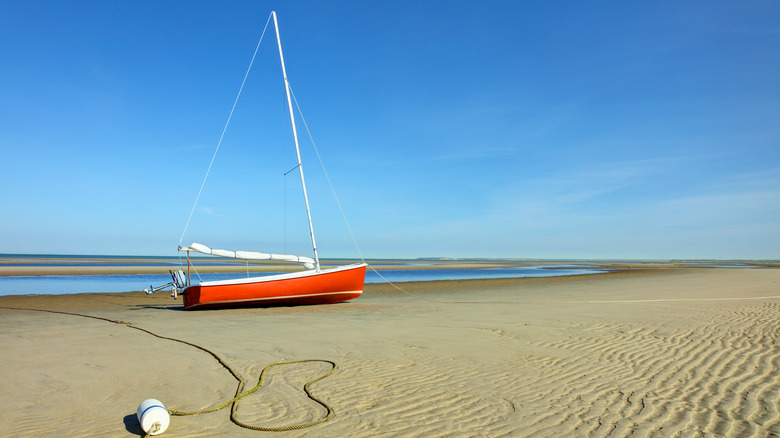 boat on beach at low tide in Cape Cod