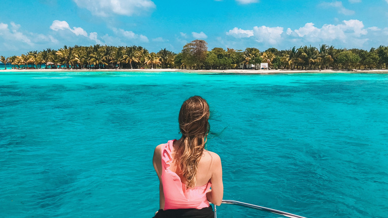A woman on a boat island hopping in Belize