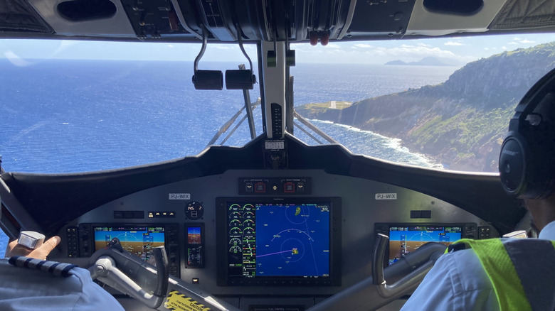 View from the cockpit with two pilots, with the runway of Saba's Juancho E. Yrausquin Airport in the background