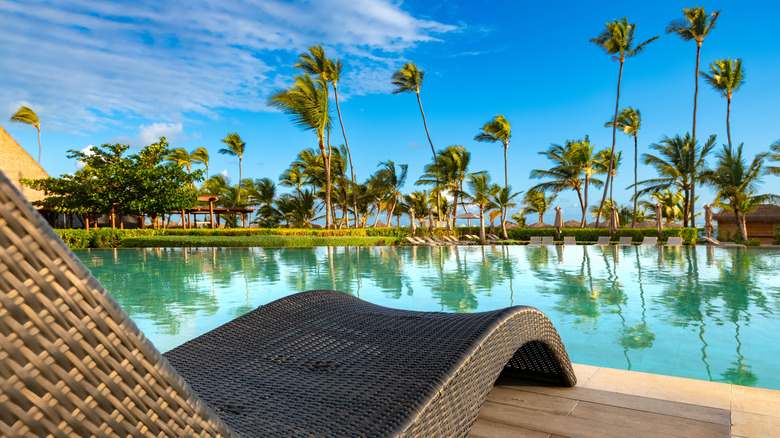 Swimming pool and palm trees in luxury resort at Punta Cana in the Dominican Republic