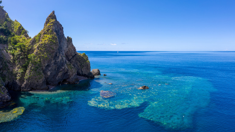 Dramatic mountain peeks and reefs below the Caribbean waters of Dominica