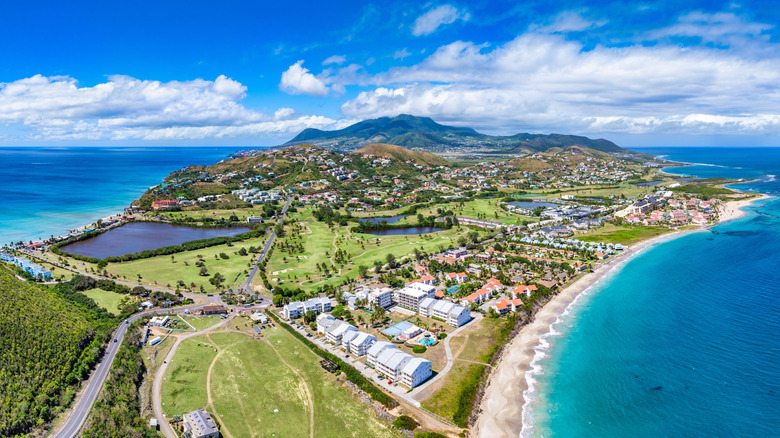Aerial view of condominiums, beaches, and mountains on St. Kitts