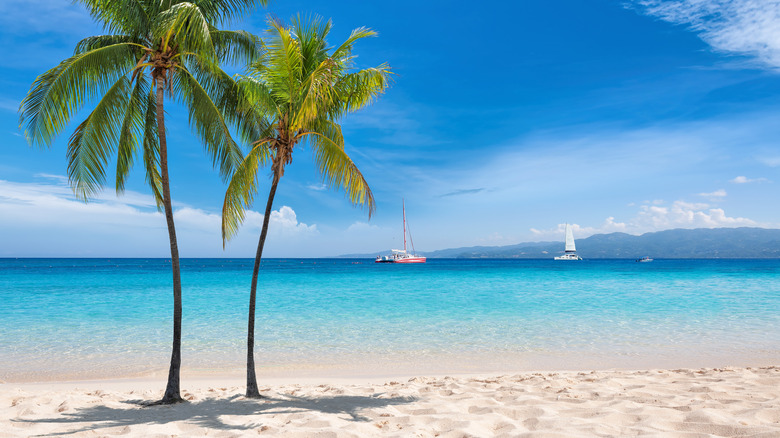 Beautiful clear blue waters and white sands on the beach in Montego Bay, Jamaica