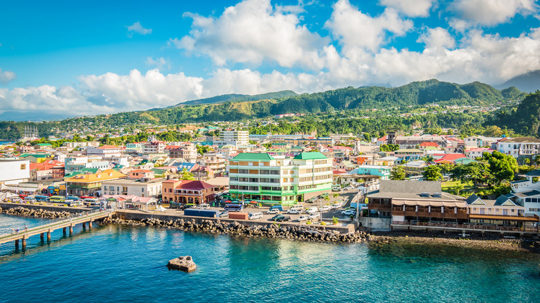 A view of the coastal capitol Roseau against green mountains on the Caribbean island of Dominica