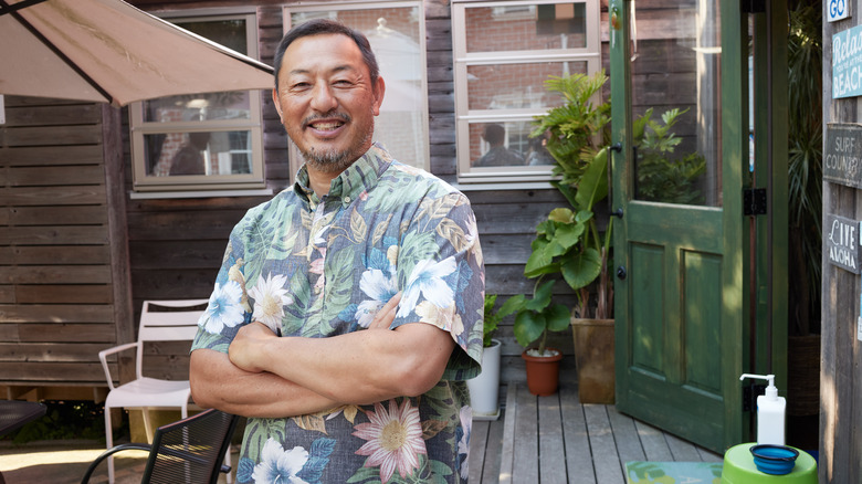 Man wearing Hawaiian-style T-shirt