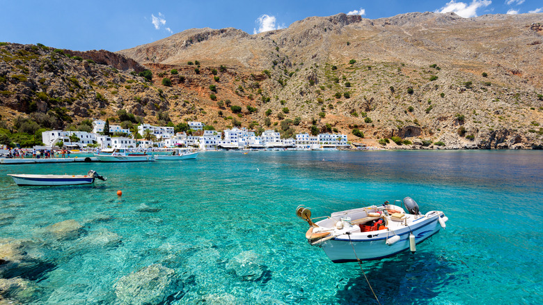 Boat floating on clear waters in Crete, Greece