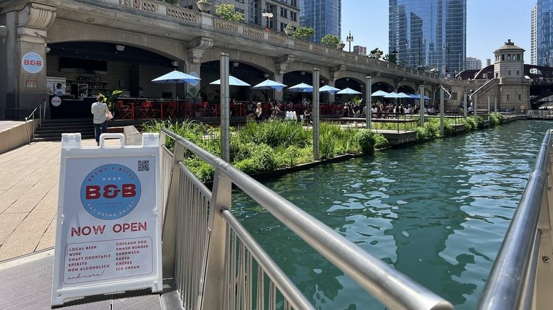 Outdoor seating at Brews & Bites on the Riverwalk on a sunny day