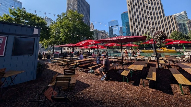 Tables at the Northman Beer & Cider Garden on the Riverwalk on a sunny day