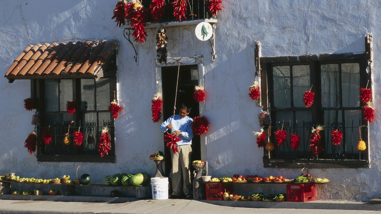 Man prepares his storefront for the Hatch Chile Festival in New Mexico