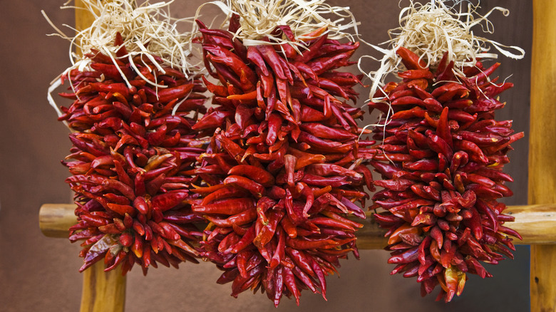 Three chile ristras hanging on strings
