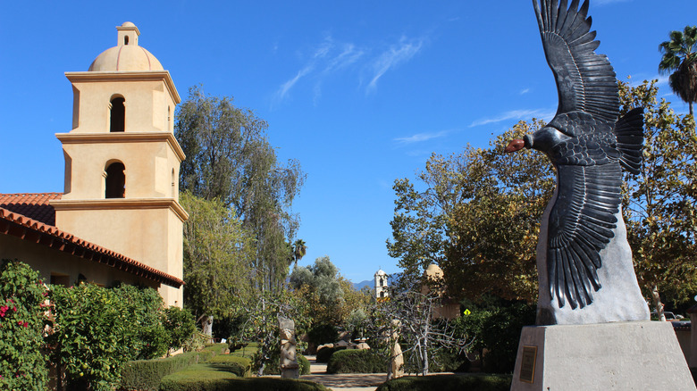 Manicured gardens and a vulture sculpture surround St. Thomas Aquinas Catholic Church, in Ojai, California.