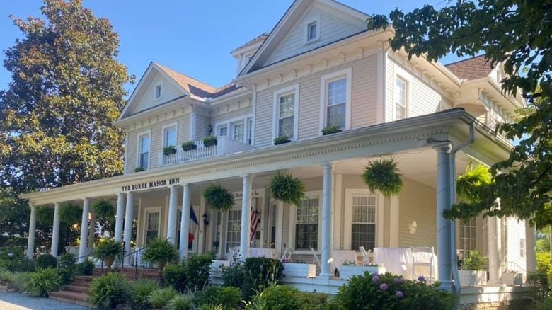 Sunlit exterior of Burke Manor Inn with lightly colored Southern design