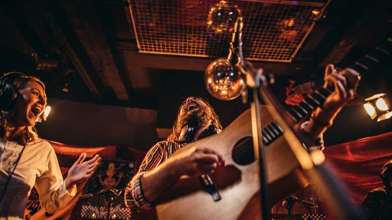 Close-up view of musicians performing with guitar