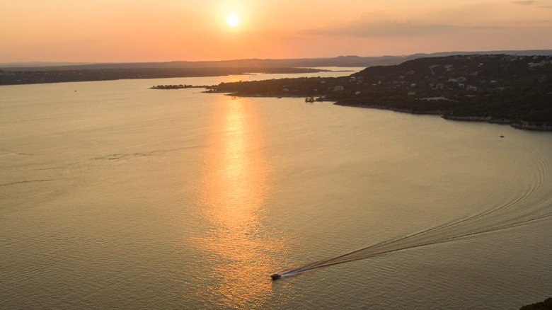 A boat on Lake Travis, Texas, during sunset