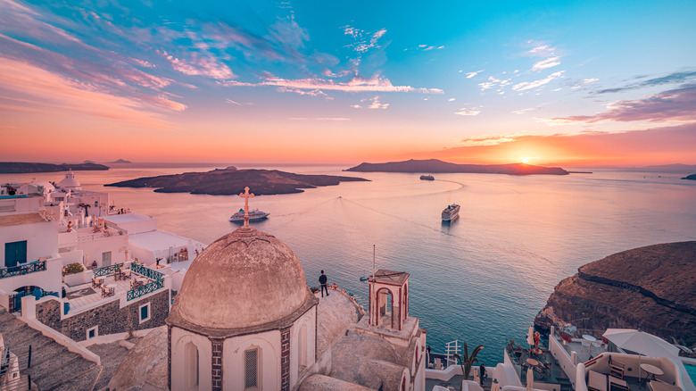 Evening landscape of Fira with ships in the water