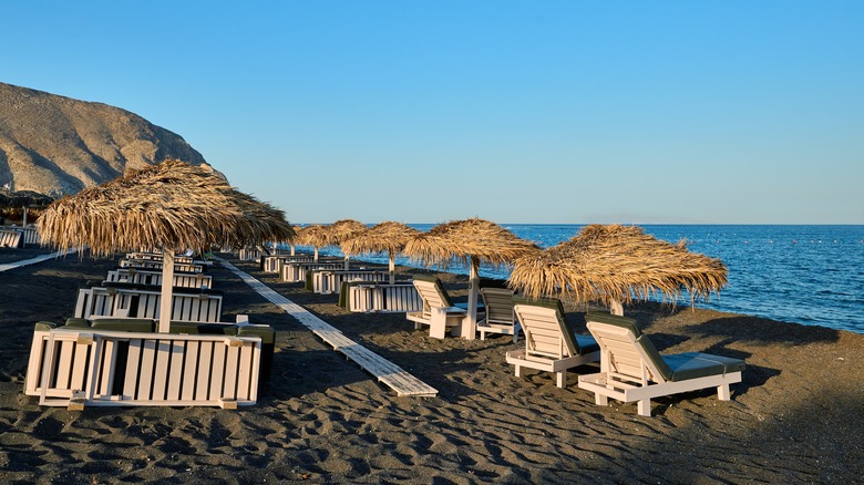 Sun loungers on Perivolos Beach in Santorini, Greece