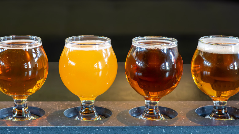 Four beers on a beer tasting paddle at a San Diego brewery