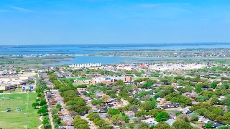 An aerial view of suburb The Colony in Denton County, Texas with Lewisville Lake in the background