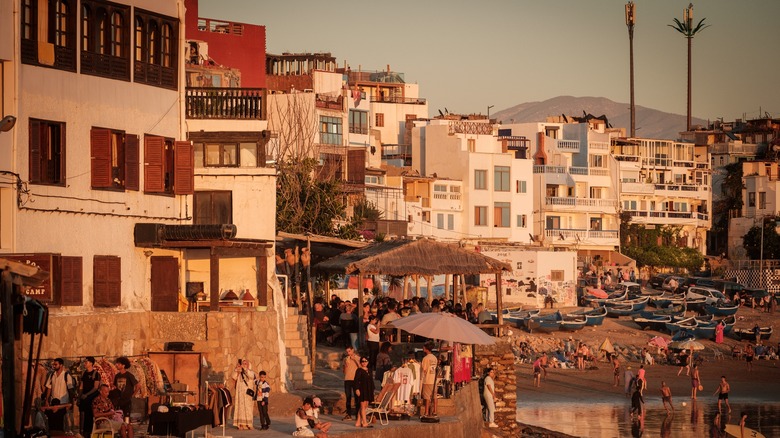 Sunset over a busy beach in Taghazout