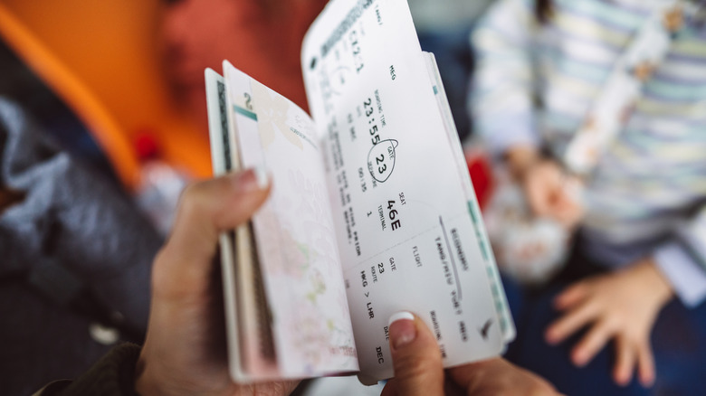Person with a paper boarding pass