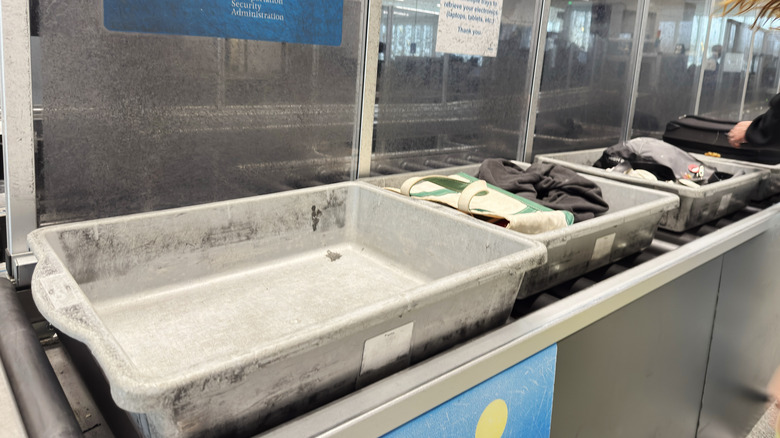 Bins on conveyor belt going through airport security